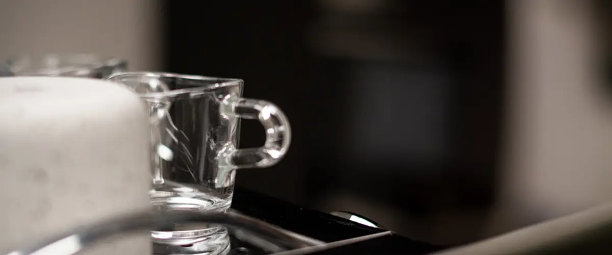 Glazen espresso kopje op een espressomachine